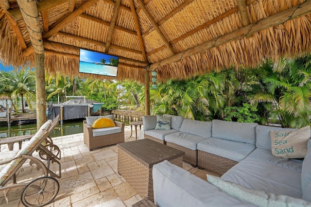 view of patio / terrace with a gazebo, an outdoor living space, a water view, and a jacuzzi