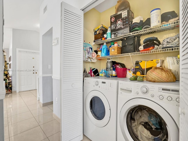 clothes washing area with separate washer and dryer and light tile patterned floors