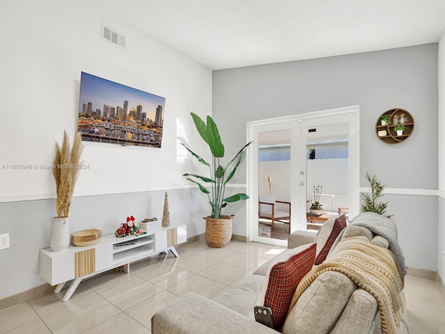 tiled living room featuring french doors