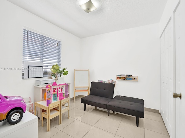 rec room with light tile patterned flooring