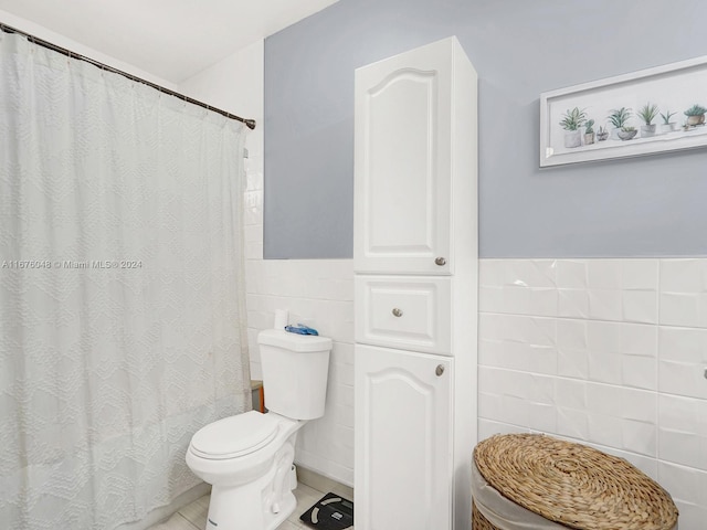 bathroom featuring tile patterned flooring, toilet, tile walls, and walk in shower