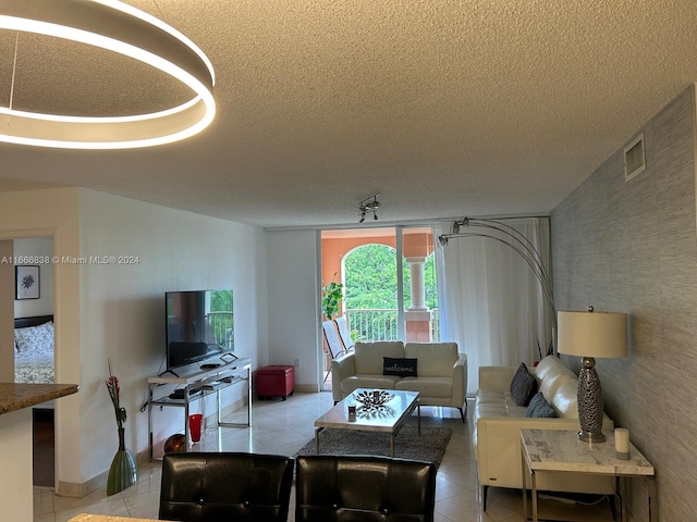 living room with light tile patterned floors and a textured ceiling