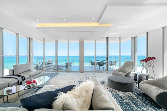 sunroom / solarium featuring a water view and a wealth of natural light