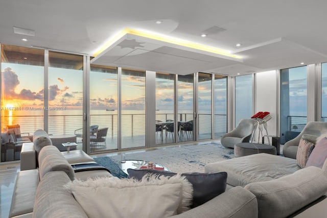 living room featuring a water view and floor to ceiling windows