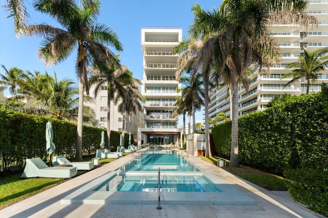 view of swimming pool featuring a community hot tub