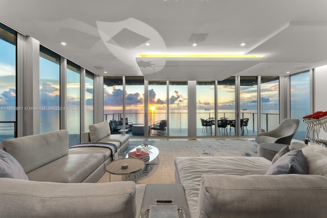 living room with a water view and floor to ceiling windows