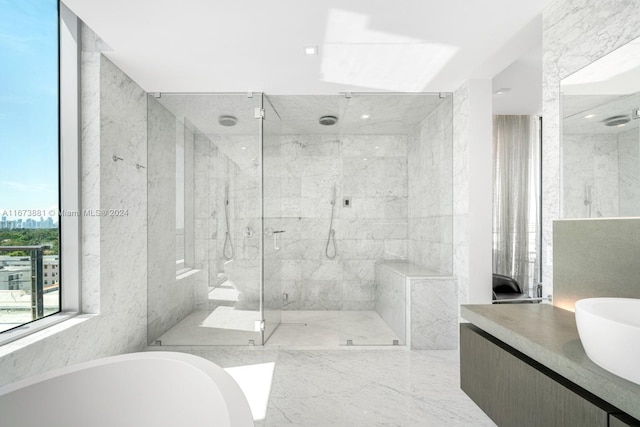 bathroom featuring tile walls, vanity, and independent shower and bath