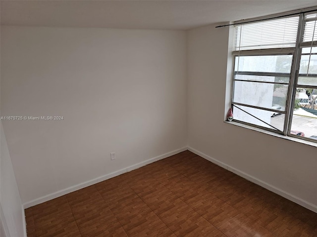 unfurnished room featuring baseboards