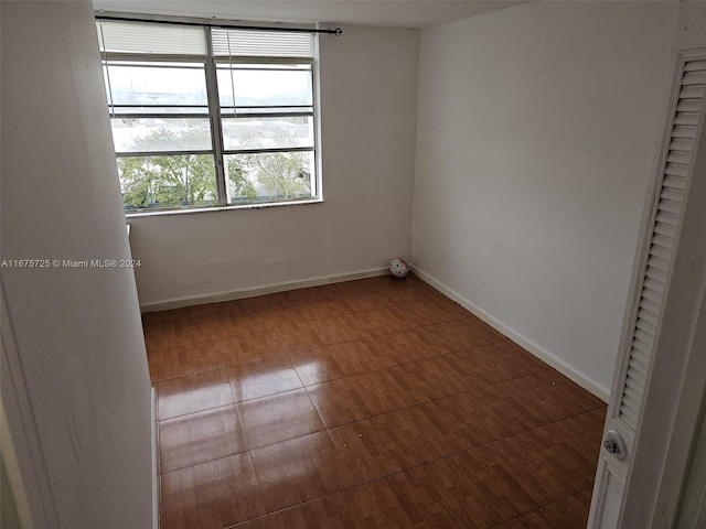 spare room featuring baseboards