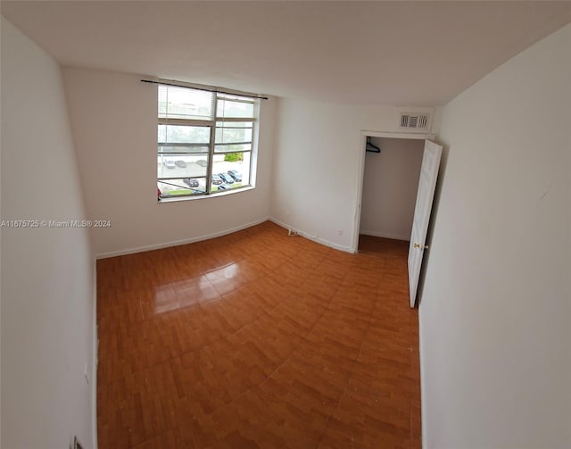 unfurnished room featuring visible vents
