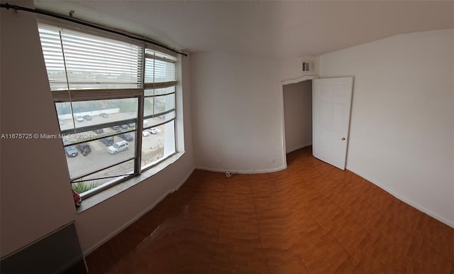 empty room with visible vents and baseboards