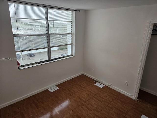 unfurnished room with baseboards and visible vents