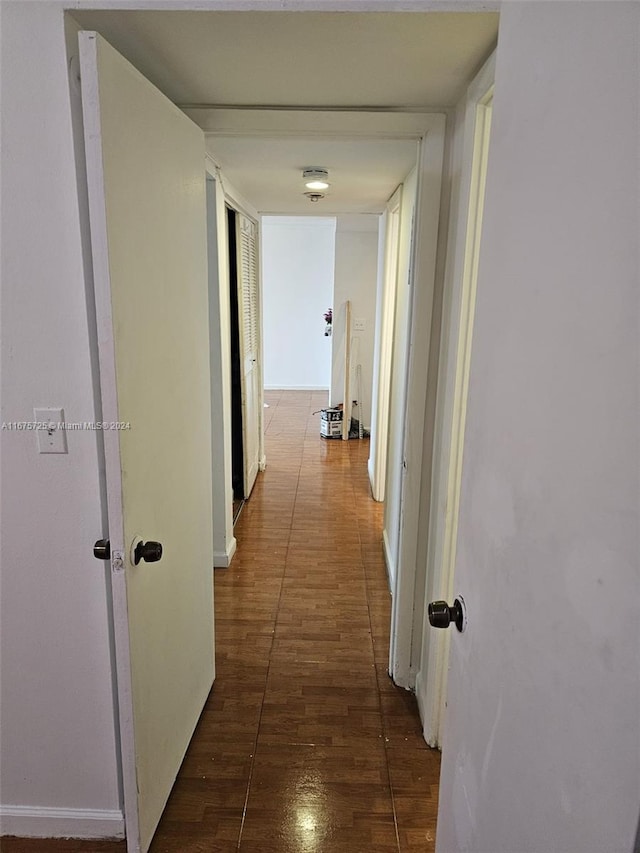 hall with dark hardwood / wood-style flooring