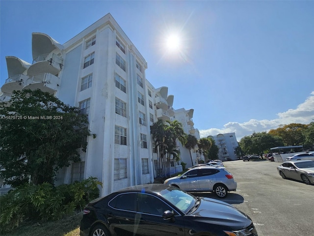 view of property featuring uncovered parking