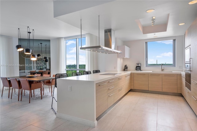 kitchen featuring wall chimney exhaust hood, light brown cabinetry, sink, kitchen peninsula, and black electric stovetop