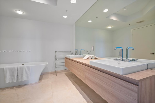 bathroom with a tub and vanity