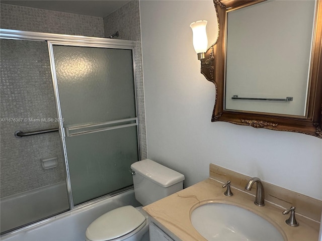 full bathroom with toilet, vanity, and shower / bath combination with glass door