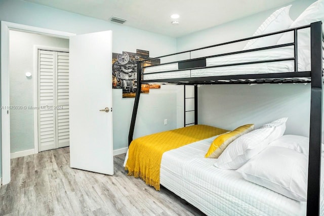 bedroom featuring light wood-type flooring and a closet