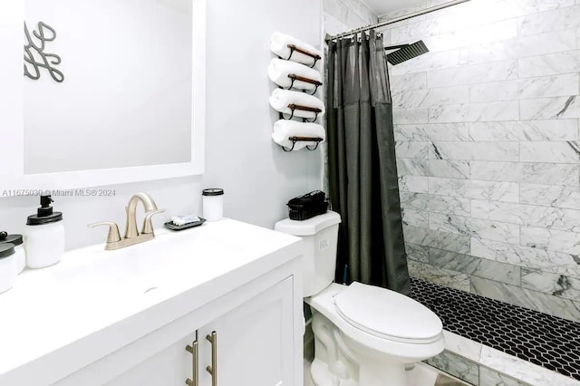 bathroom with toilet, vanity, and a shower with shower curtain