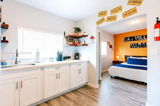 bedroom featuring sink and light hardwood / wood-style floors