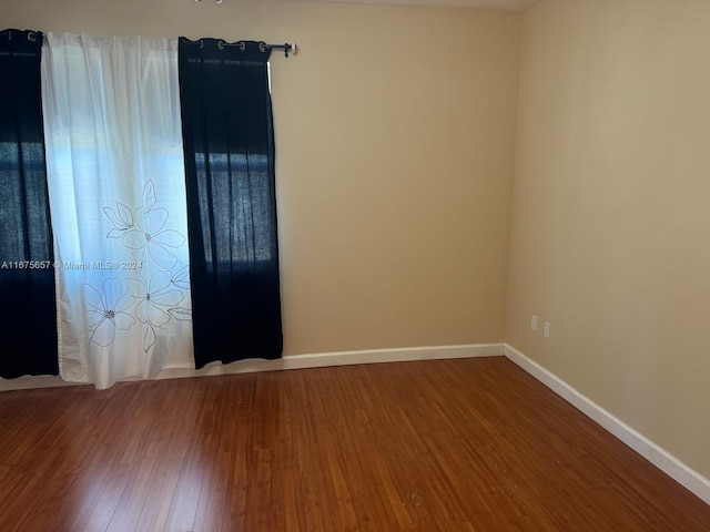 spare room featuring wood-type flooring