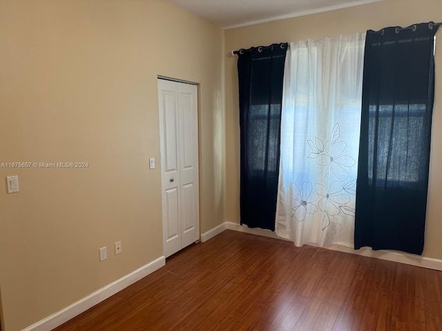 spare room featuring wood-type flooring