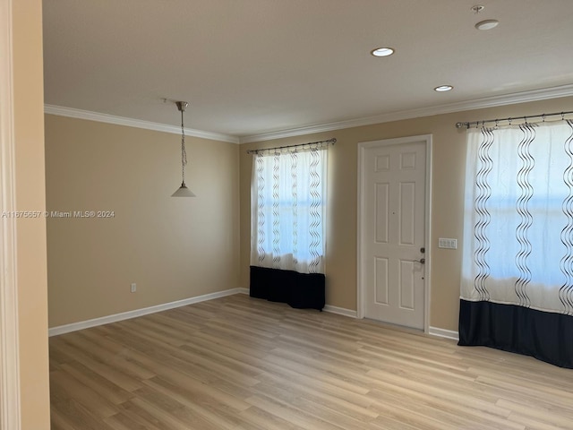 unfurnished room featuring light hardwood / wood-style floors and ornamental molding