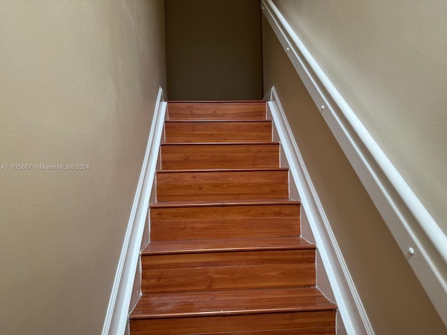 staircase with hardwood / wood-style floors