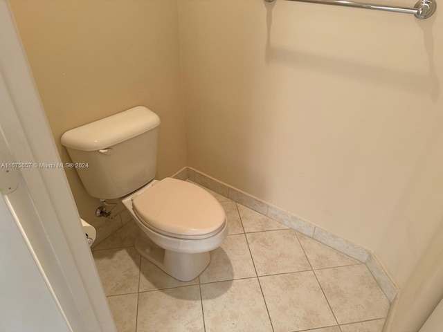 bathroom with tile patterned flooring and toilet