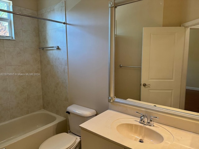 full bathroom with toilet, tiled shower / bath combo, and vanity