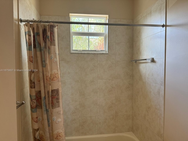 bathroom with shower / bath combination with curtain