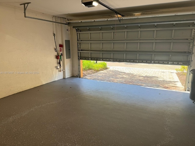 garage featuring electric panel and a garage door opener