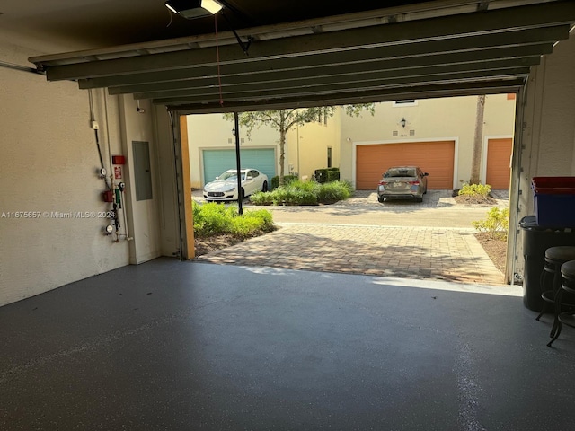 garage with electric panel and a garage door opener