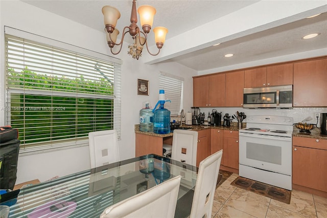 kitchen with a notable chandelier, decorative light fixtures, sink, and white range with electric cooktop