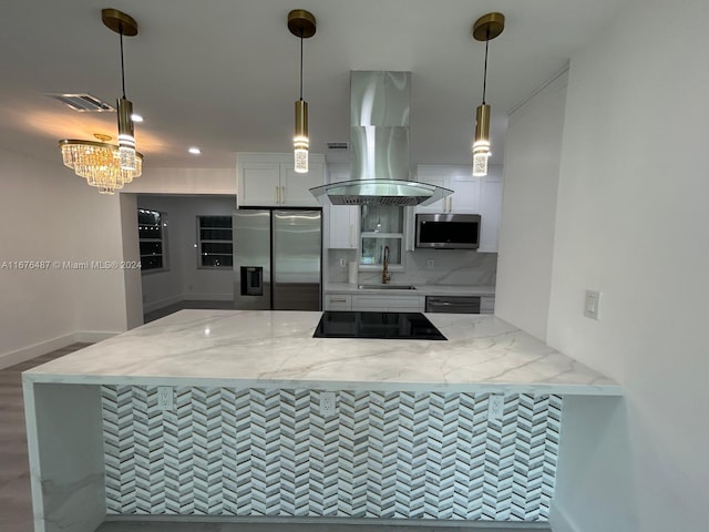 kitchen with white cabinets, stainless steel appliances, hanging light fixtures, and sink