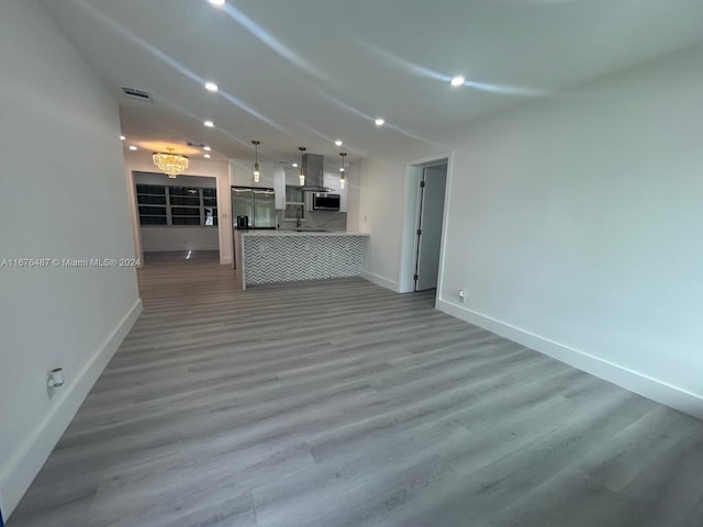 unfurnished living room with hardwood / wood-style floors