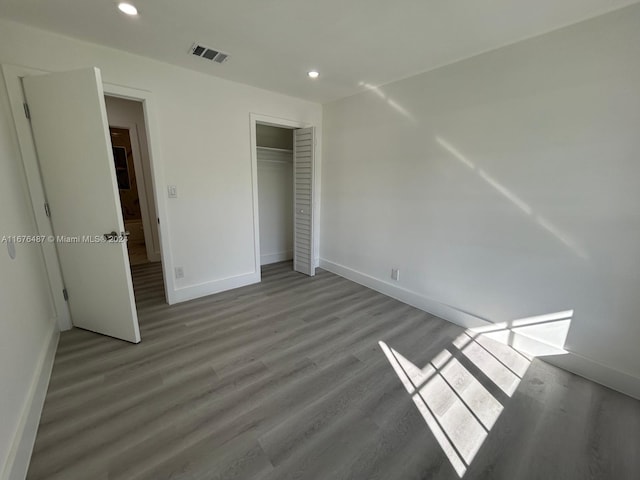 unfurnished bedroom featuring a closet and light wood-type flooring