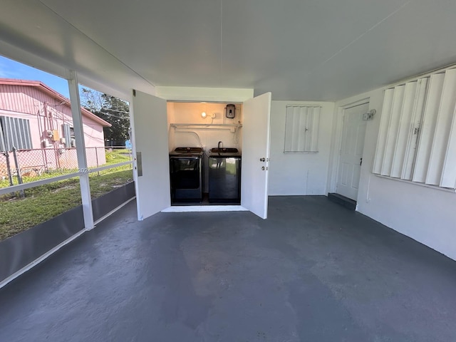 unfurnished sunroom featuring washing machine and dryer