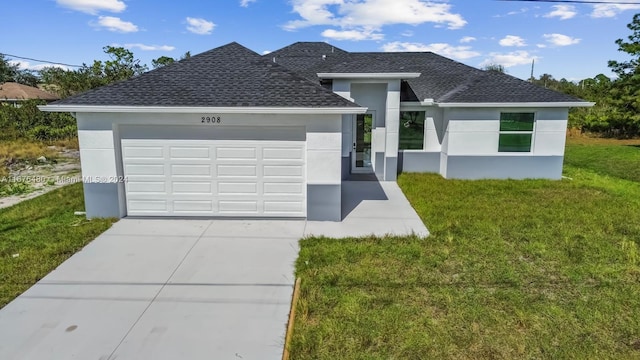 view of front facade with a front yard and a garage