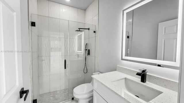 bathroom featuring vanity, toilet, and walk in shower