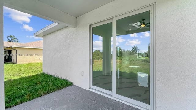 doorway to property featuring a lawn