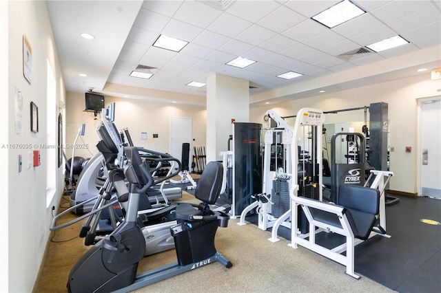 gym with a drop ceiling, baseboards, and visible vents