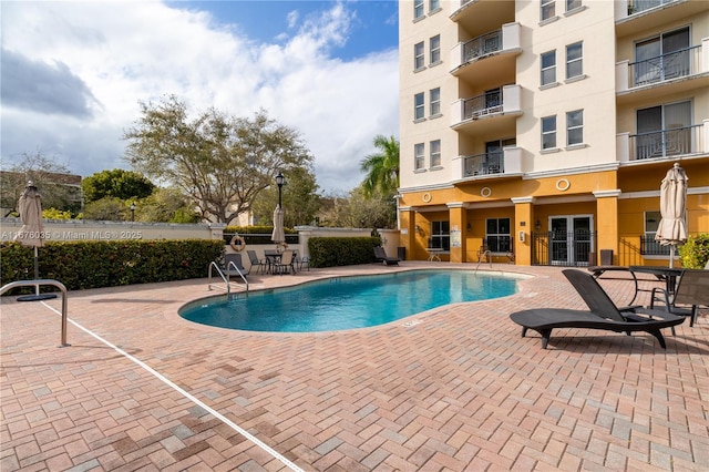 pool featuring a patio and fence