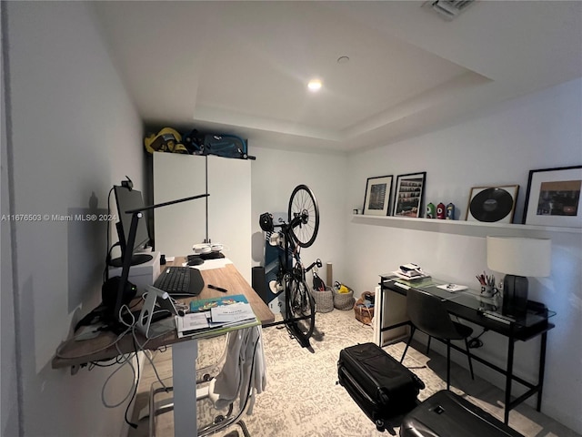 workout room with a raised ceiling