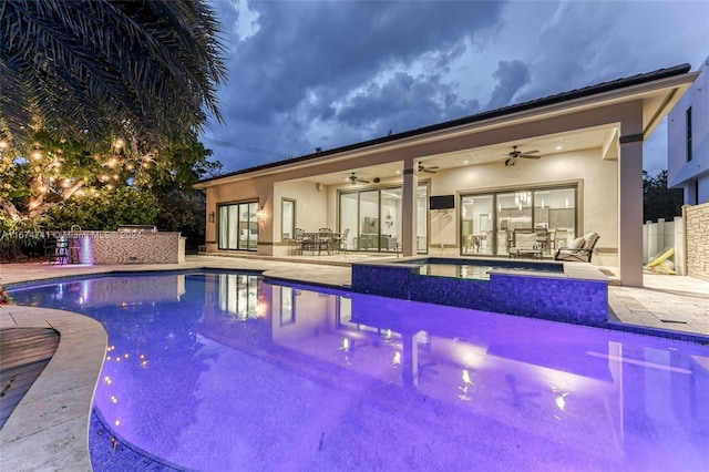 view of pool with a patio area and ceiling fan