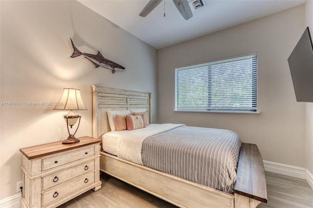 bedroom with wood-type flooring and ceiling fan