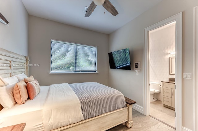 bedroom with light wood-type flooring, ensuite bath, and ceiling fan