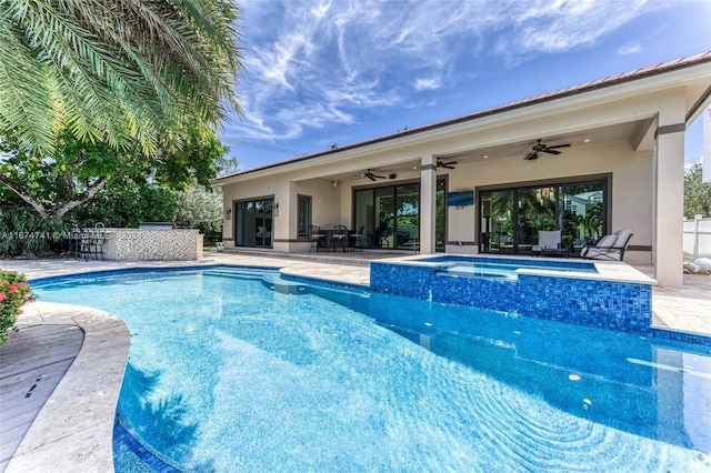 view of swimming pool featuring an in ground hot tub, ceiling fan, and a patio