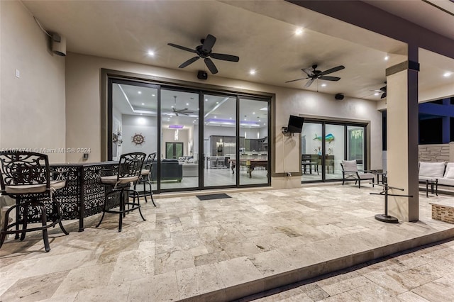 view of patio / terrace featuring ceiling fan and french doors