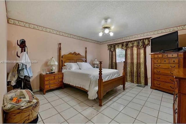 bedroom with ceiling fan, a textured ceiling, and light tile patterned floors